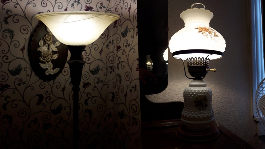 Image of two lamps. One is a tall floor model while the other is a small bedside lamp.